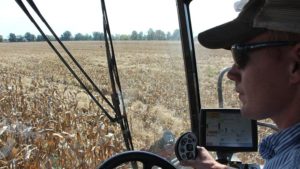 Farm manager Nate Long in the cab as he traverses the field during fall harvest 2016.