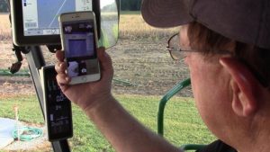AgriSync farmer with iPhone
