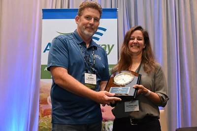 Joe Gifford (left) of Syngenta is presented the 2022 Ron Storms Leadership Award by Ann Vande Lune of ag retailer Key Cooperative. She was the recipient of the same award in 2019.